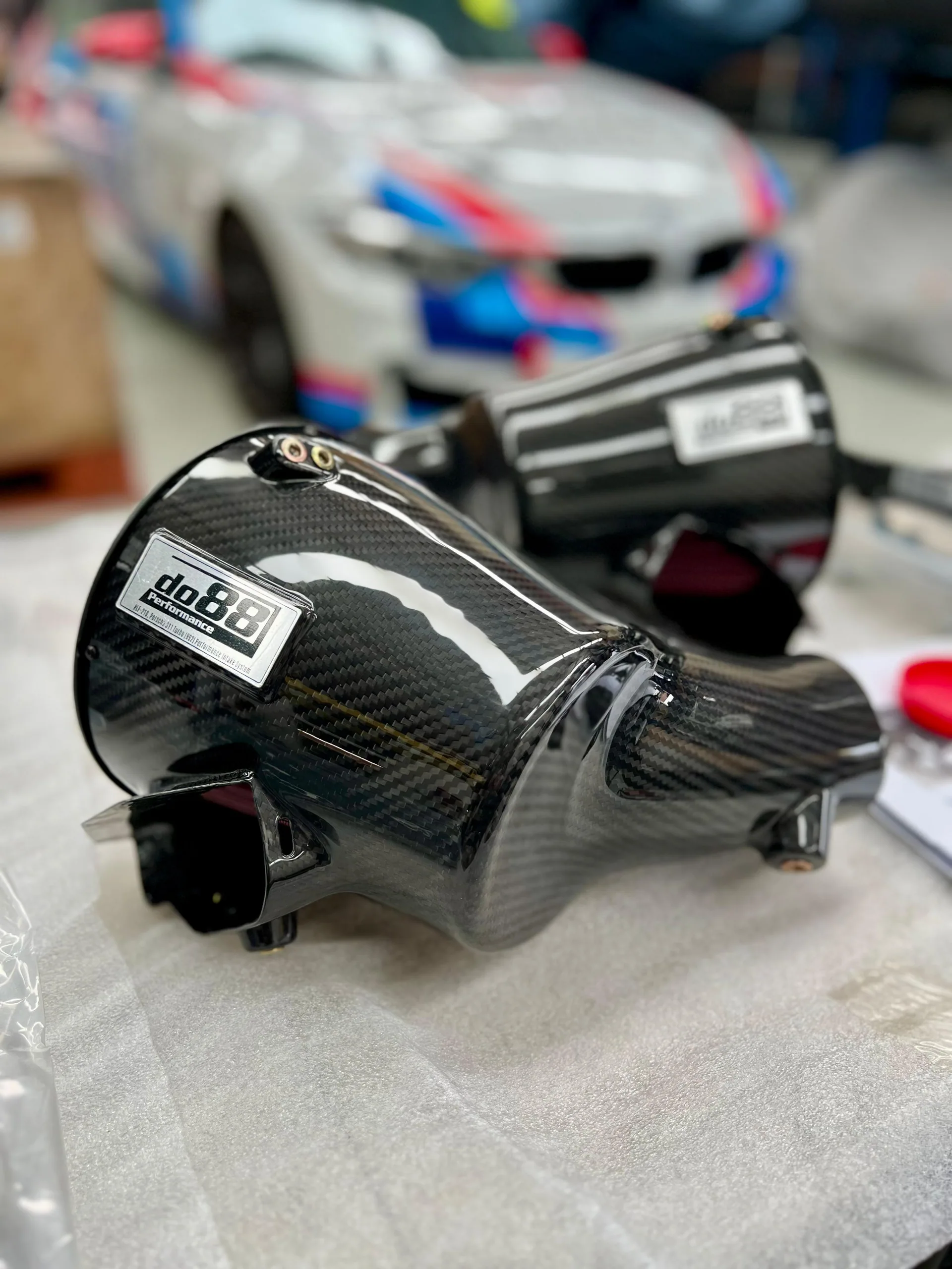 Carbon-fibre performance air intake displayed at the Etuners workshop